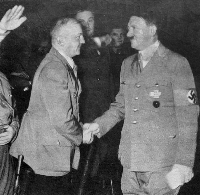 Adolf Hitler greets Gauleiter Wagner at the Christmas party in Loewenbraeukeller